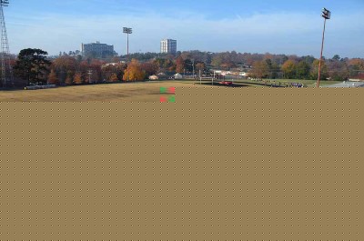 Runners make their way around the track and across a field.