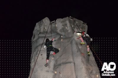 A couple of climbers racing for the top in the rain.