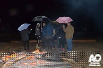 Volunteers, fans and team members took advantage of one of two bonfires to keep warm.