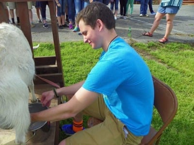 My second blue-eyed baby milking a goat!
