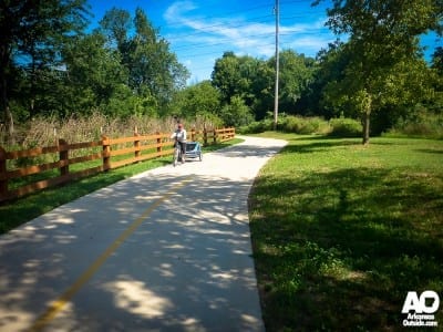 Mom pulling her child along the Greenway.