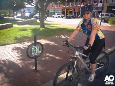 Lisa, waiting in the Bentonville Square for me to find her some dirt to ride.