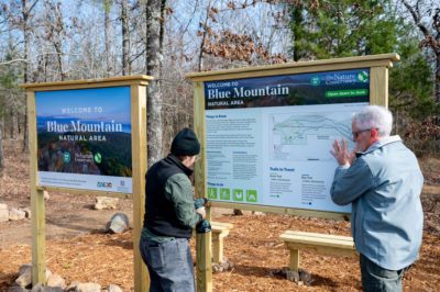 Trailhead signs being installed.