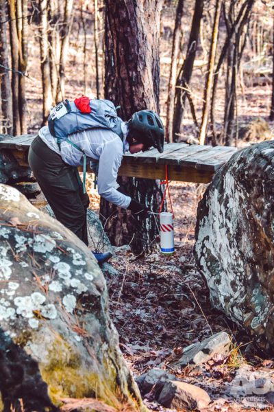 A team member punches their passport at a checkpoint at Rattlesnake Ridge.