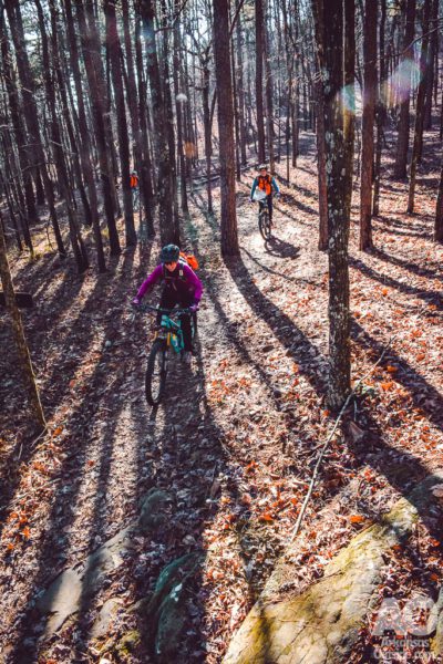 A team mountain bikes through Rattlesnake Ridge.