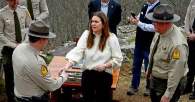 The Governor handing out Centennial Pins to the park staff
