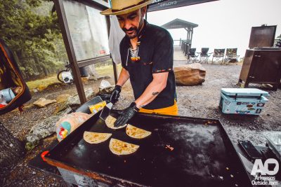Jackalope Cycling owner, Johnny Brazil, serving up quesadillas on the Bench Trail throughout the day.