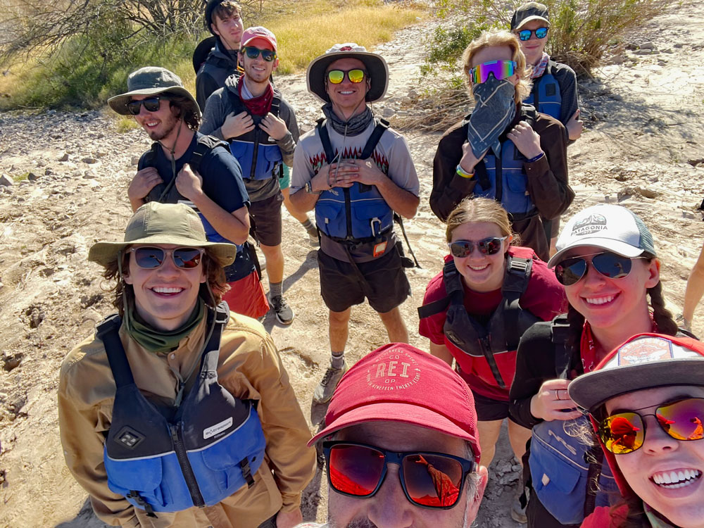Students pause for a group photo while scouting a rapid during an applied outdoor leadership course on the Rio Grande River.