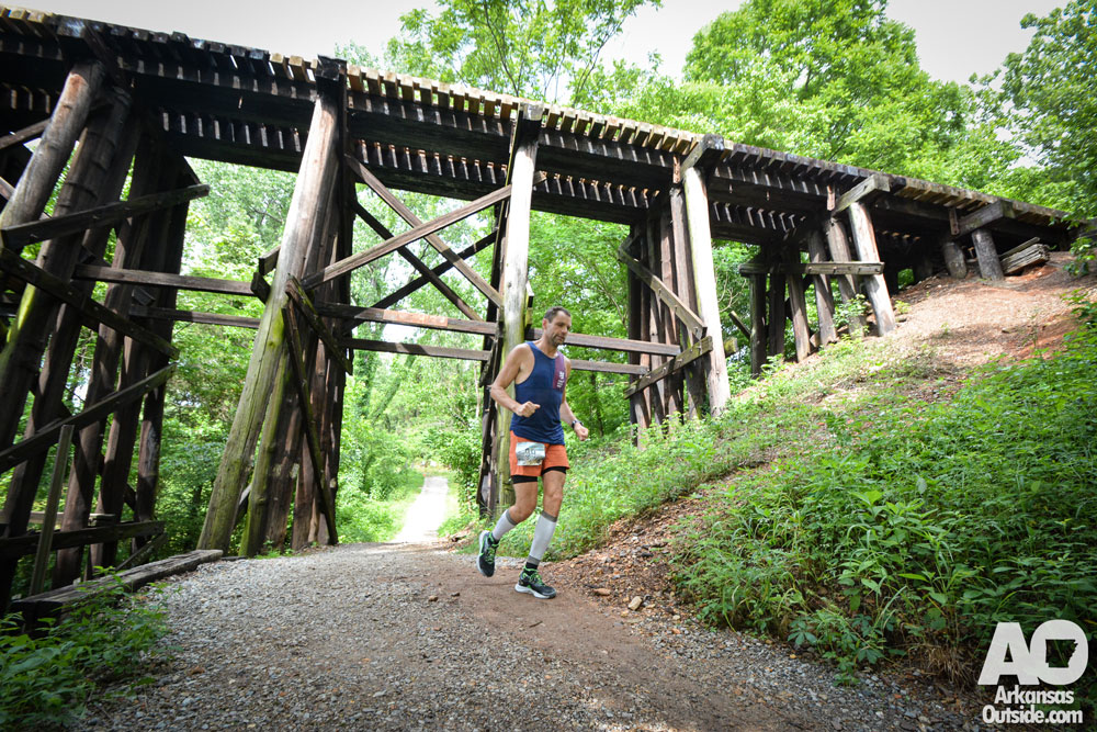 A runner passing the railroad bridge coming into the finish of another yard.