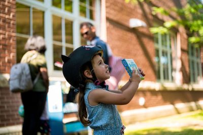 Child holds up a book.