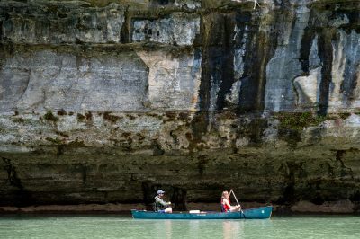 Canoeist enjoying a float below one of the many bluffs.