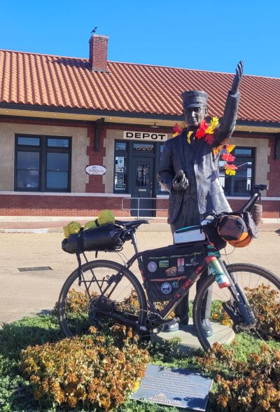 A bikepacking rig leans on the Conductor Statue at the Russellville Depot. The Depot will be the start and finish line for the Arkansas High Country Race for 2024 and 2025. Photo by Jackalope Cycling.