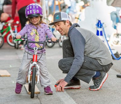 Founder Scott Fitzgerald working with a young cyclist.