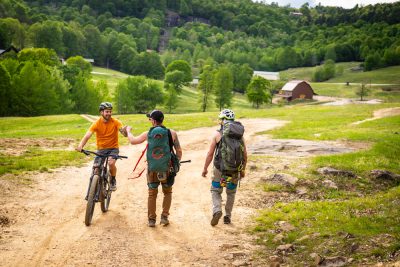 A mountain biker and a couple of rock climbers meet on the trail.