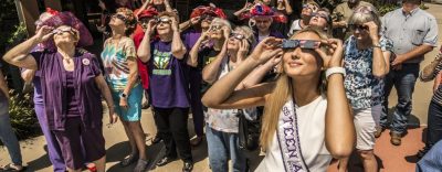 A group of people watching the eclipse.