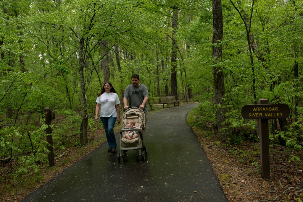 Young Family with stroller on the Kingfisher Trail at Pinnacle Mountain State Park.