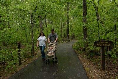 Young Family with stroller on the Kingfisher Trail at Pinnacle Mountain State Park.