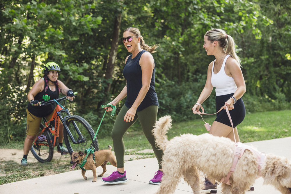 Walkers and cyclists enjoying the trails of NWA.