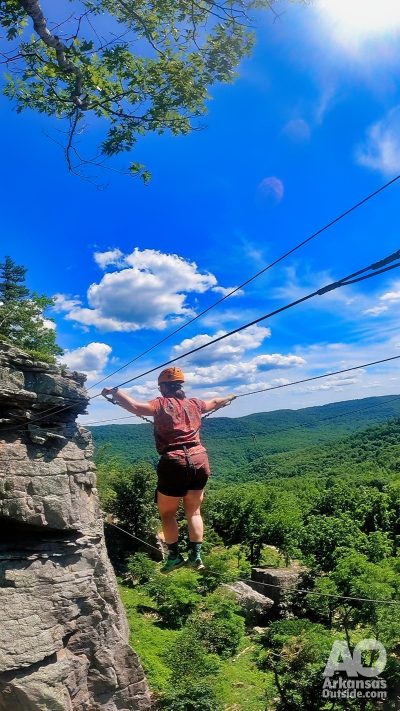 Lisa traverses The Bridge on the Via Ferrata course.