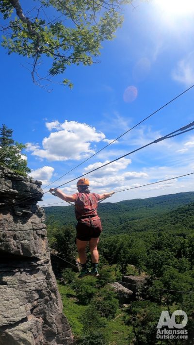 Lisa traverses The Bridge on the Via Ferrata course.