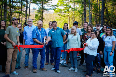 Mena Advertising and Promotions Commissioner cuts the ribbon with an assist by Mayor Erik Smith.