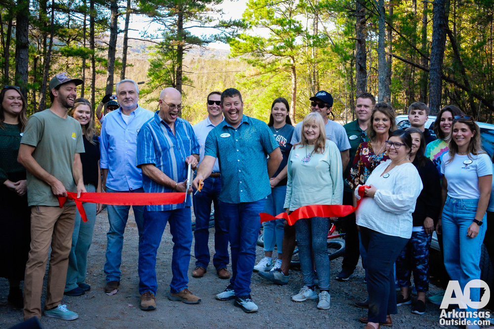 Mena Advertising and Promotions Commissioner cuts the ribbon with an assist by Mayor Erik Smith.