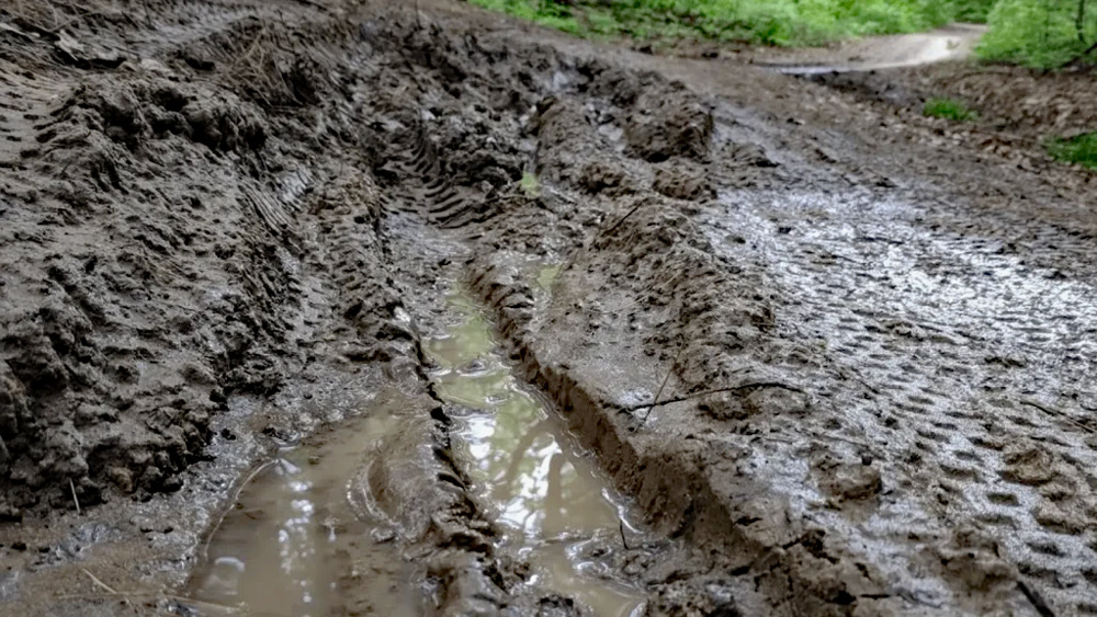 A rutted, muddy trail due to use as the ground thaws.