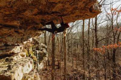 Climber working an overhang at Jamestown Crag.