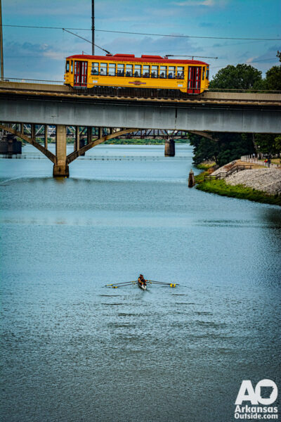One of our favorite shots from the Six Bridges Regatta. A trolley car passes over a rowing competitor.