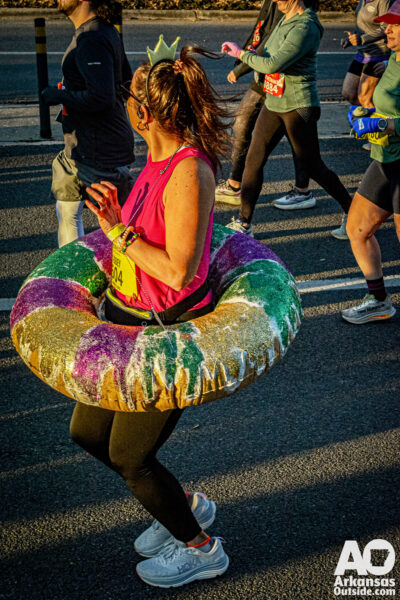 Runners embraced the Mardi Gras theme. Here we have a running king cake.