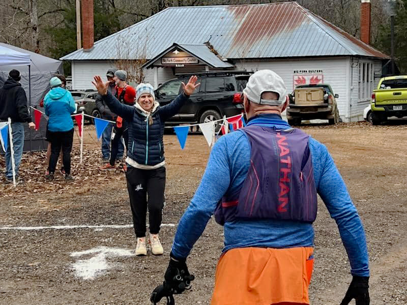 Stacey welcoming her father, John Fowlkes, to the finish line at the Athens-Big Fork Trail Marathon.