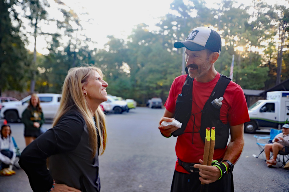 Stacey greeting an Arkansas Traveller Finisher at the line. (Photo by Debbie Rigby) Stacey Shaver trail running