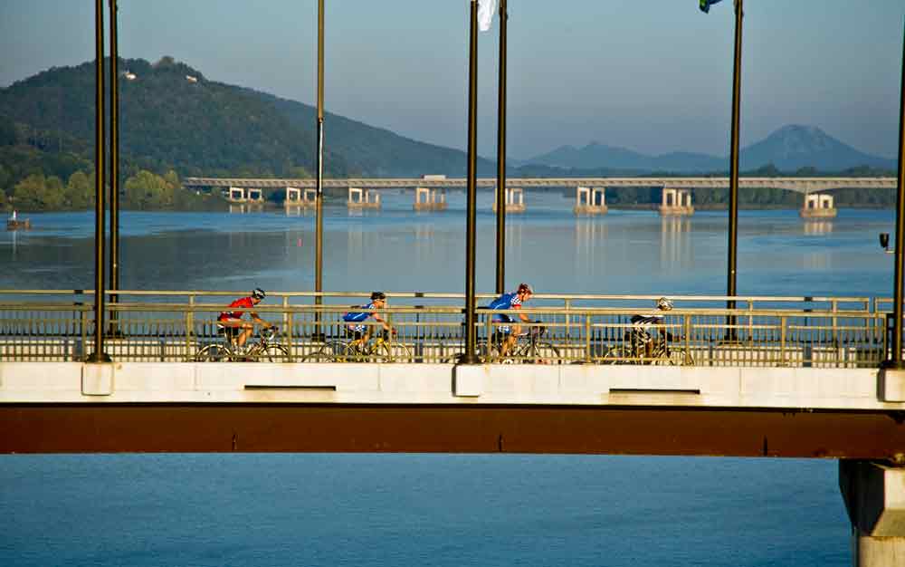 Cyclists make their way across the bridge.
