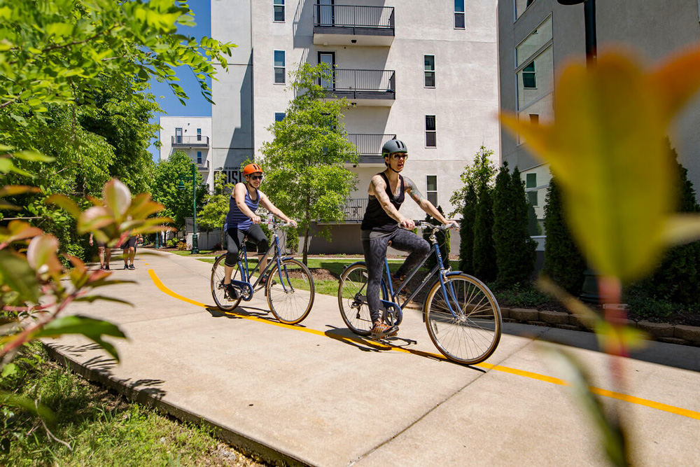 Riding through a residential area on the Razorback Greenway in Fayetteville. (Photo courtesy of Experience Fayetteville)