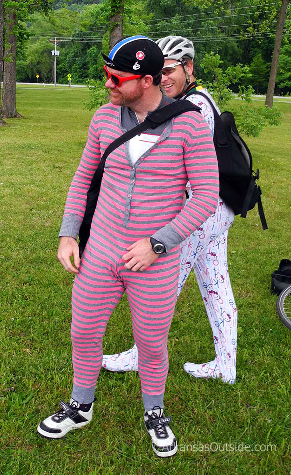 Two grown men in onesie pajamas.