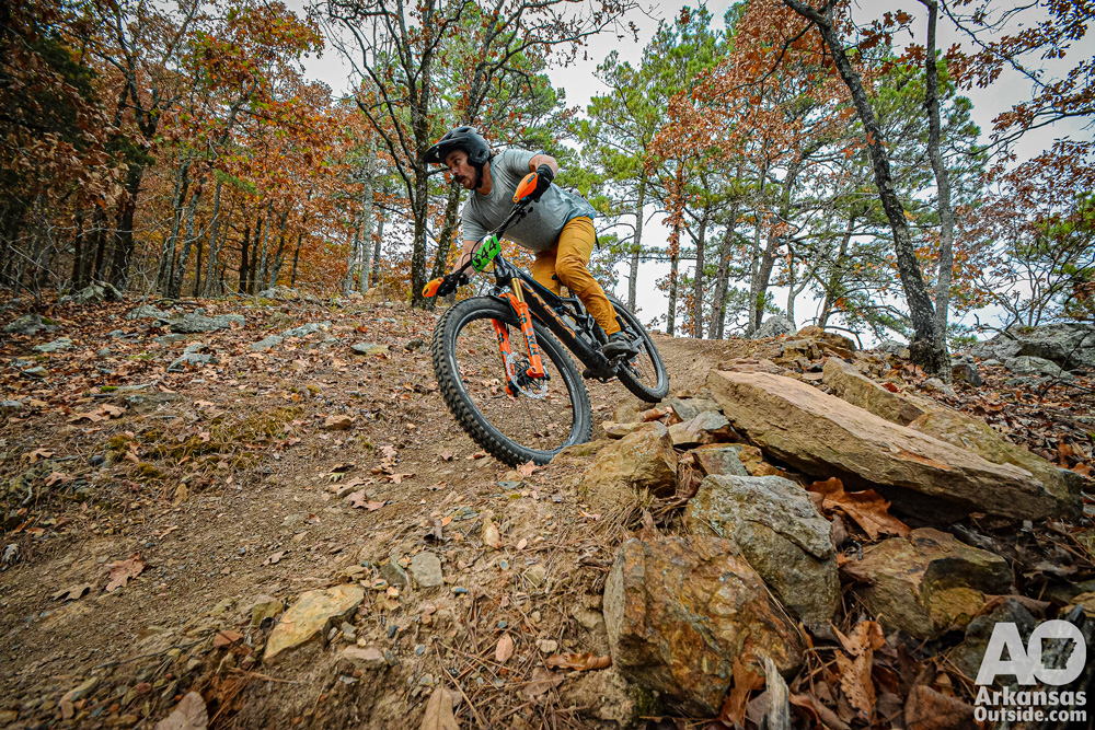 Mountain biker in a bermed, rocky turn.