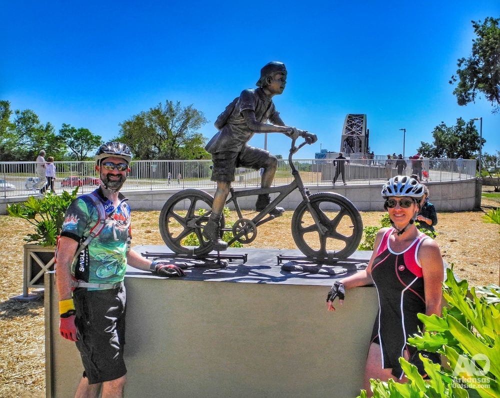 Bicycle boy statue with cyclists.