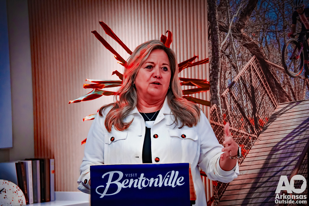 Woman speaking from a podium.