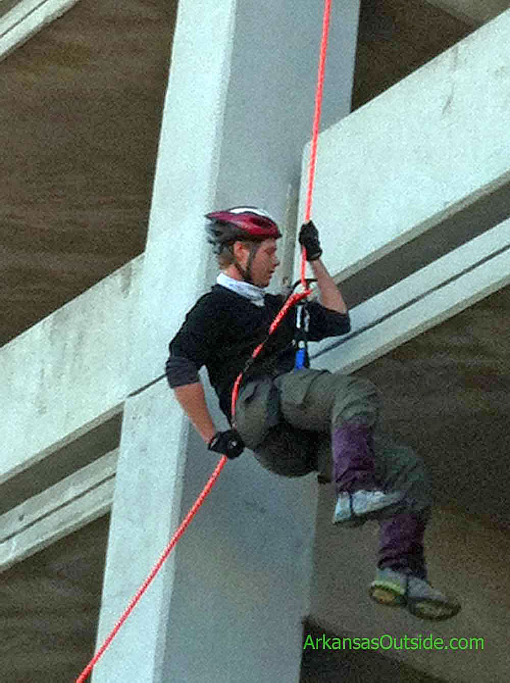 Rope work on a downtown parking deck.