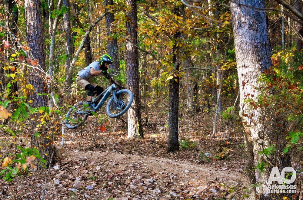 Rider getting some air at the Ward Lake Trails in Mena, soon to be connected to Queen Wilhelmina State Park.