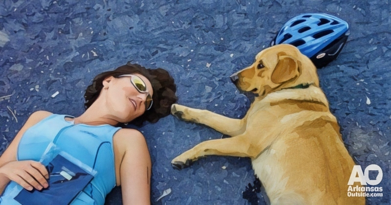Lisa rests with a new friend after a multi-sport race.