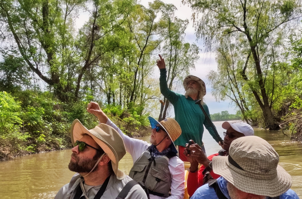 John, pointing out flora and fauna in a draw along the Mississippi River.